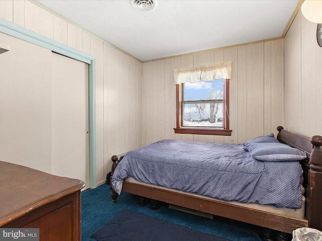 bedroom with carpet and wood walls