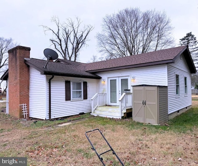 view of front of home with french doors and a front lawn