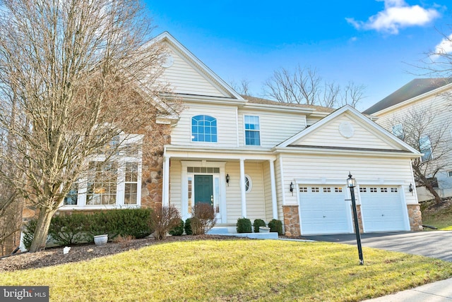 front of property featuring a front yard and a garage