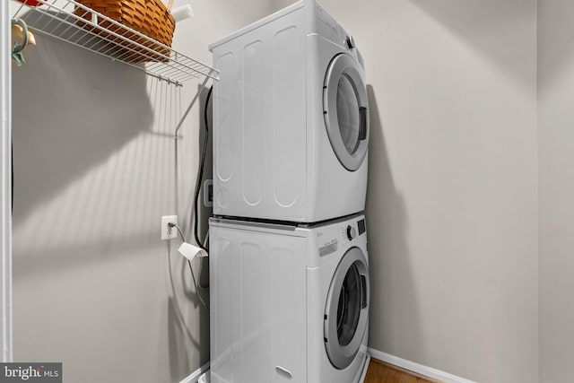 clothes washing area with stacked washer and dryer