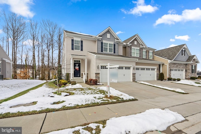 view of front of home featuring a garage and central air condition unit