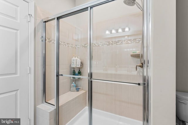 bathroom featuring toilet and walk in shower