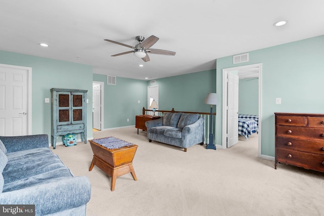 carpeted living room with ceiling fan