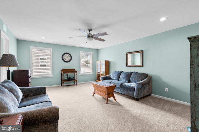 living room with ceiling fan and light colored carpet