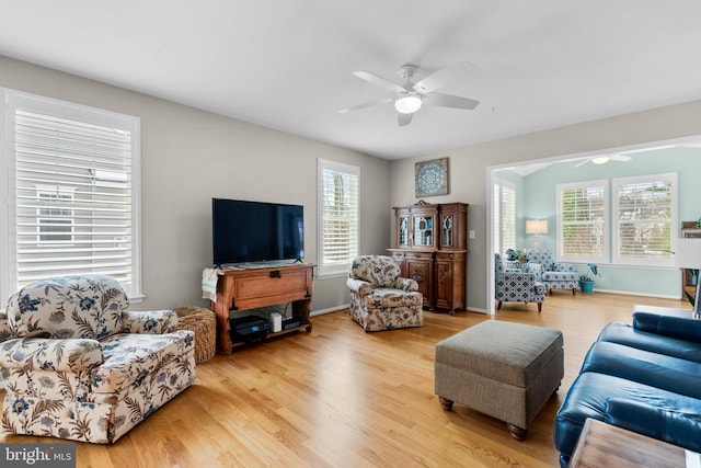 living room featuring light wood-type flooring and ceiling fan