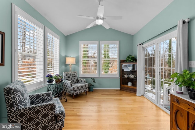 sitting room with ceiling fan, lofted ceiling, and light wood-type flooring