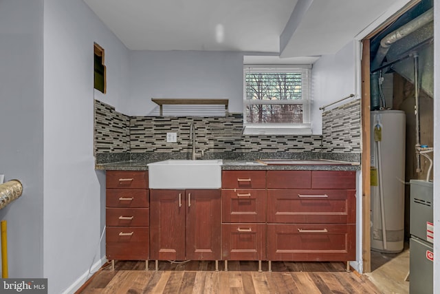 kitchen with wood-type flooring, sink, water heater, and backsplash