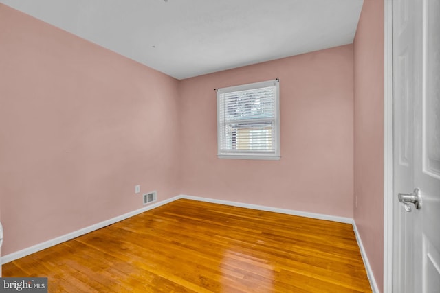 spare room with wood-type flooring