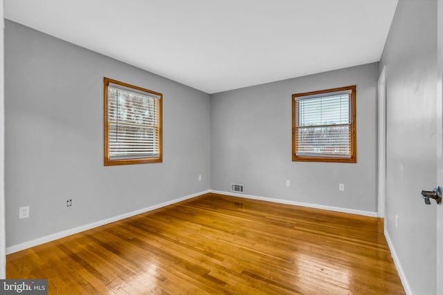 empty room with light hardwood / wood-style floors