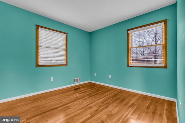 unfurnished room featuring hardwood / wood-style flooring