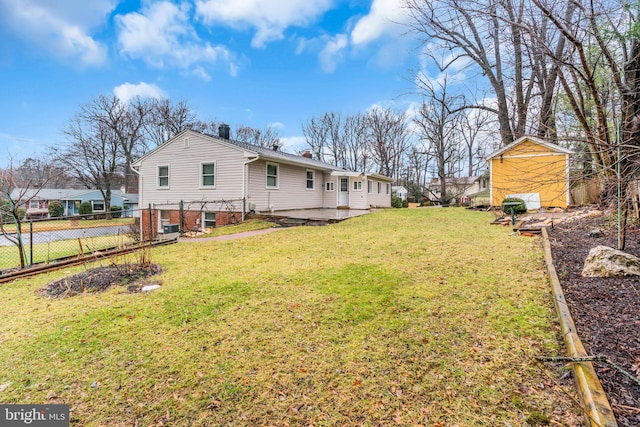 rear view of property with a yard