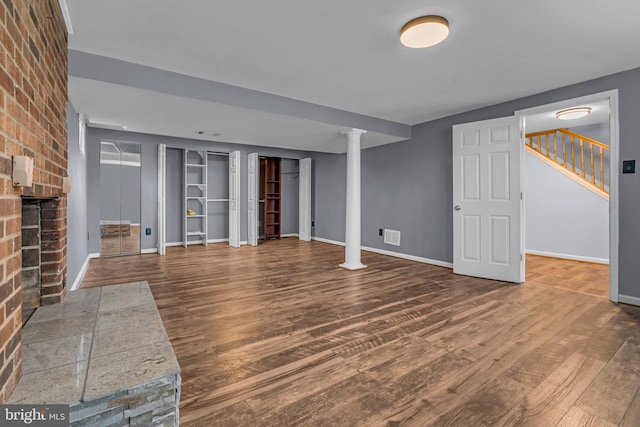 unfurnished living room with wood-type flooring and a fireplace