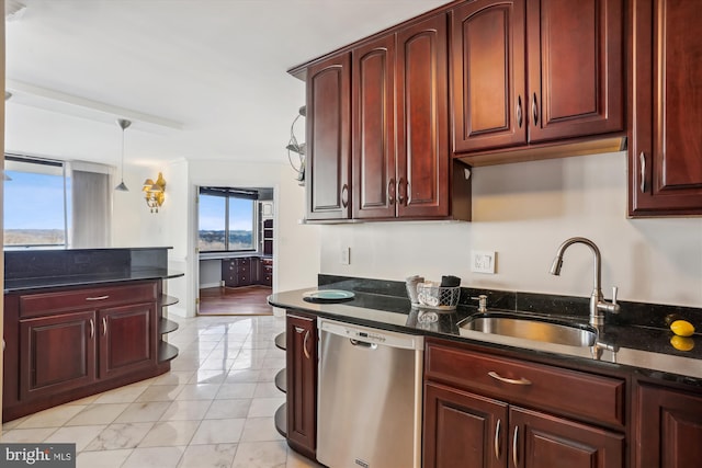 kitchen with dishwasher, sink, pendant lighting, and dark stone counters