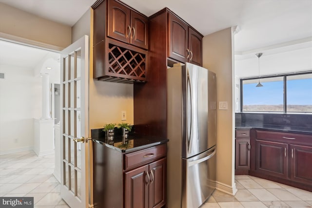 kitchen with light tile patterned floors and stainless steel refrigerator