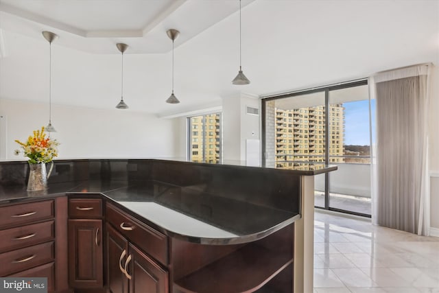 kitchen with light tile patterned flooring and decorative light fixtures