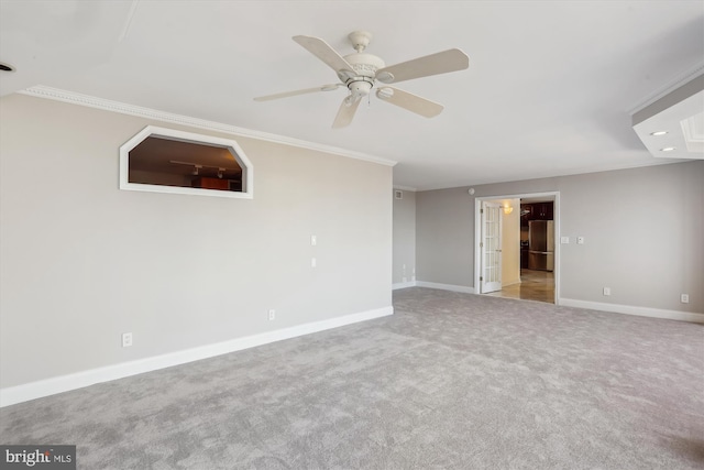 carpeted empty room with ornamental molding and ceiling fan