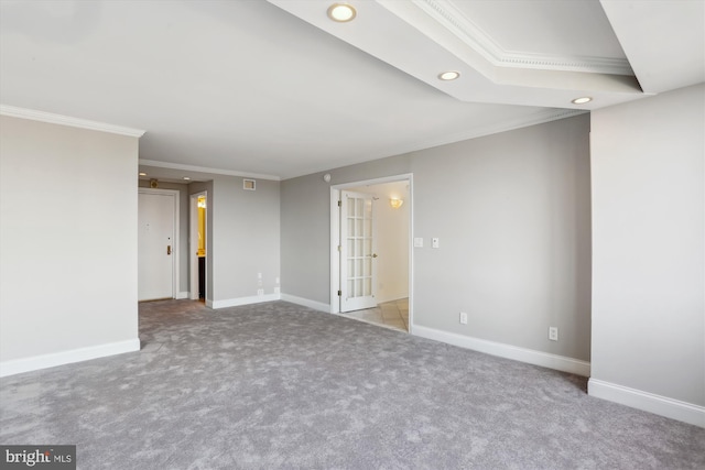 empty room with crown molding and light colored carpet