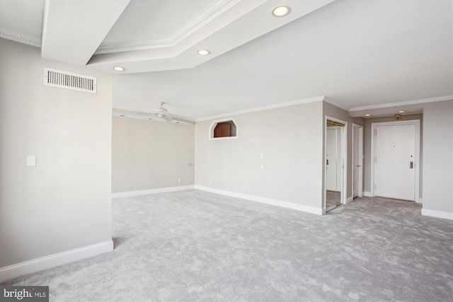 spare room with crown molding, ceiling fan, and carpet floors