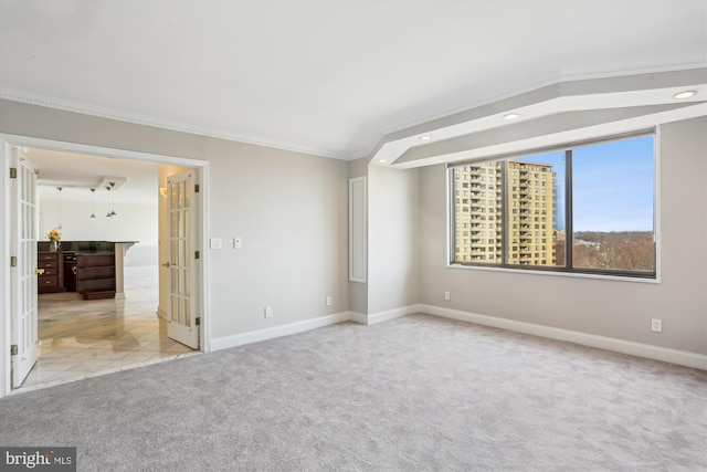 unfurnished room with light carpet, ornamental molding, and french doors