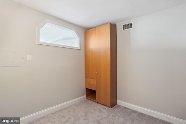 unfurnished bedroom featuring light carpet