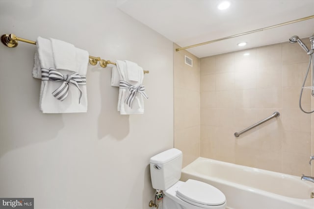 bathroom featuring toilet and tiled shower / bath combo