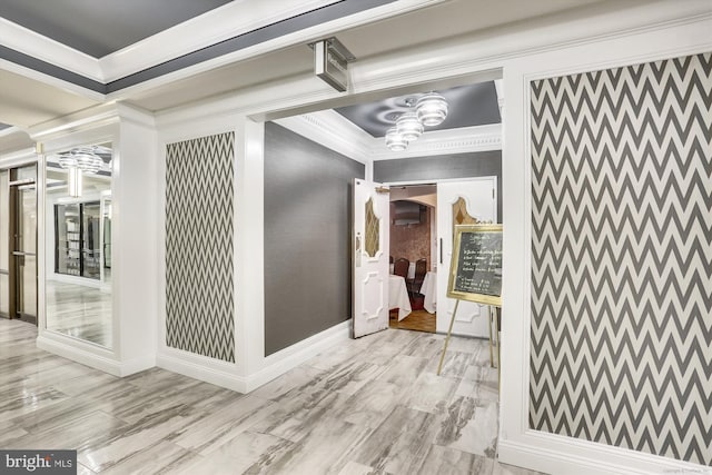 hall featuring crown molding and light hardwood / wood-style floors