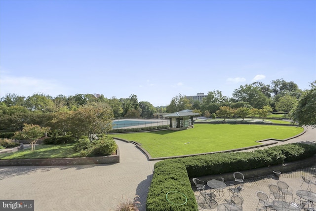 view of property's community with a gazebo, a swimming pool, and a yard