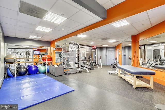 exercise room featuring a paneled ceiling