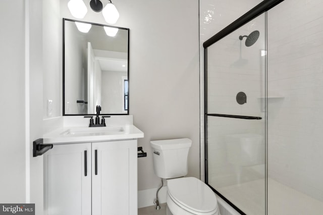 bathroom featuring vanity, toilet, and an enclosed shower