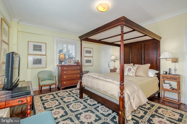 bedroom featuring hardwood / wood-style flooring and crown molding