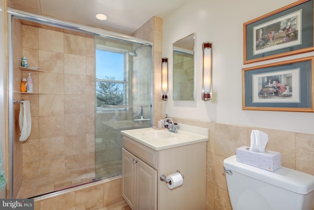 bathroom featuring vanity, toilet, and a shower with door