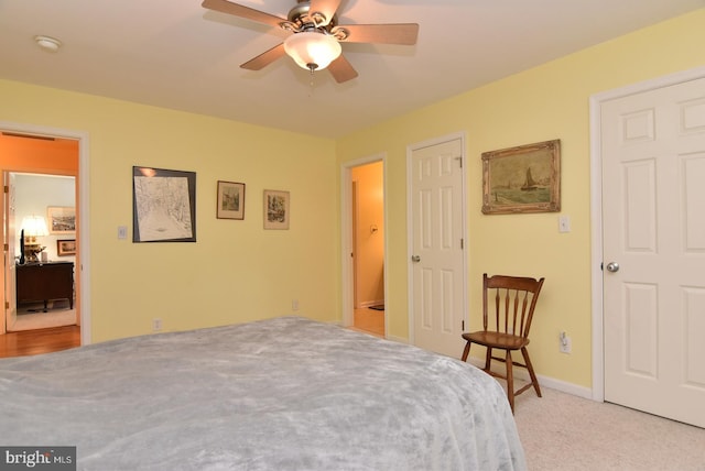 bedroom with ceiling fan and light carpet