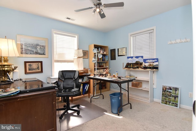 office space with light carpet and ceiling fan