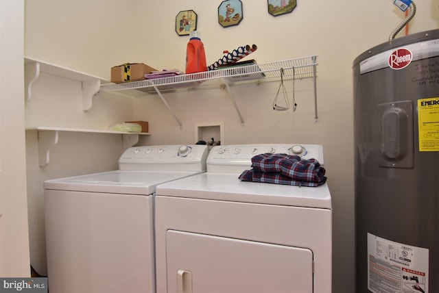 laundry room with independent washer and dryer and water heater