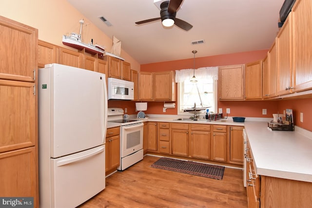 kitchen with ceiling fan, sink, hanging light fixtures, light hardwood / wood-style floors, and white appliances