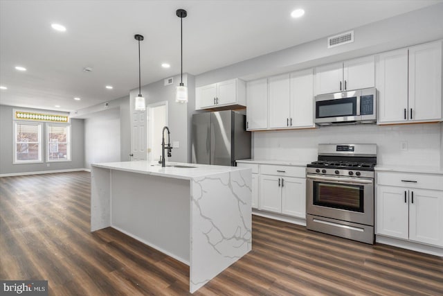 kitchen featuring white cabinets, appliances with stainless steel finishes, and sink