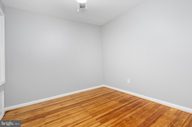 unfurnished room featuring hardwood / wood-style floors