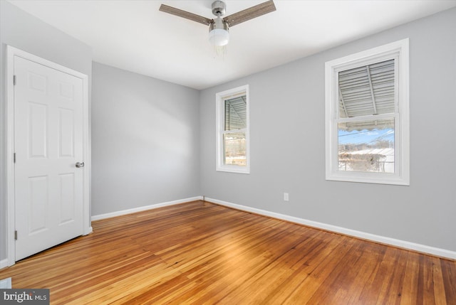 spare room featuring hardwood / wood-style flooring and ceiling fan