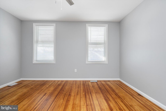 spare room with wood-type flooring and ceiling fan