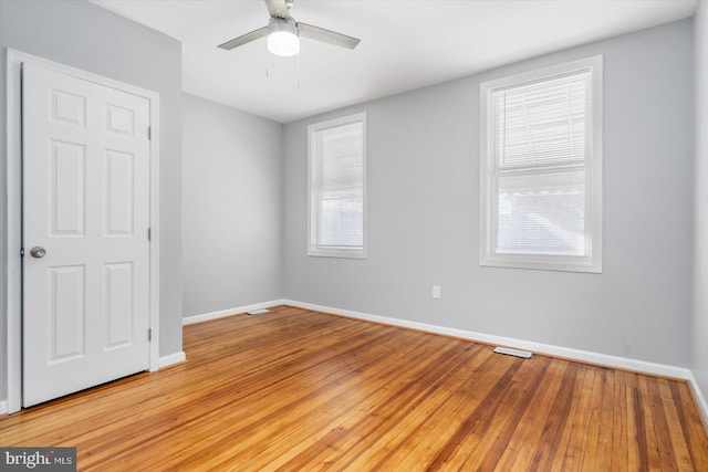 empty room featuring ceiling fan and light hardwood / wood-style floors