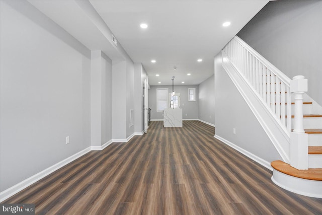 unfurnished living room featuring dark hardwood / wood-style flooring