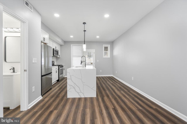 kitchen with white cabinetry, sink, dark hardwood / wood-style flooring, pendant lighting, and appliances with stainless steel finishes