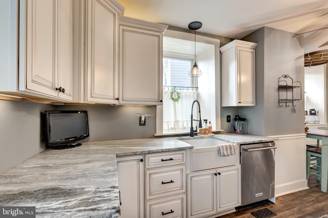 kitchen featuring dishwasher, sink, light stone counters, dark hardwood / wood-style floors, and decorative light fixtures