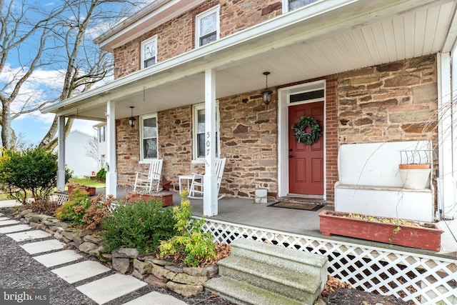 view of exterior entry with covered porch