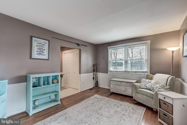 sitting room with wood-type flooring