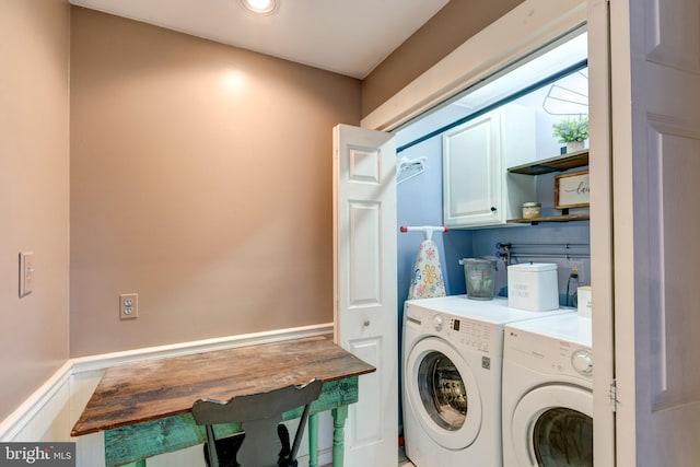 laundry area with washer and clothes dryer and cabinets