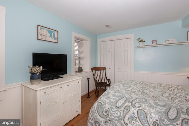 bedroom with a closet and light hardwood / wood-style floors