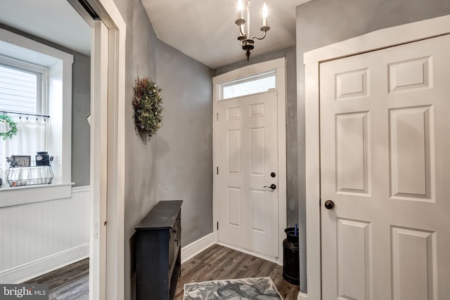 entryway featuring a chandelier and dark wood-type flooring