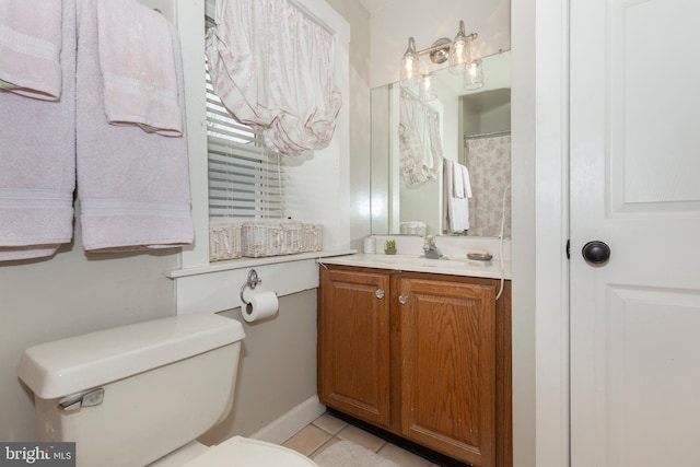 bathroom with tile patterned floors, vanity, and toilet