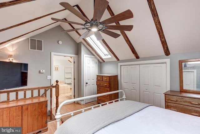 bedroom with lofted ceiling with skylight, ceiling fan, and hardwood / wood-style flooring